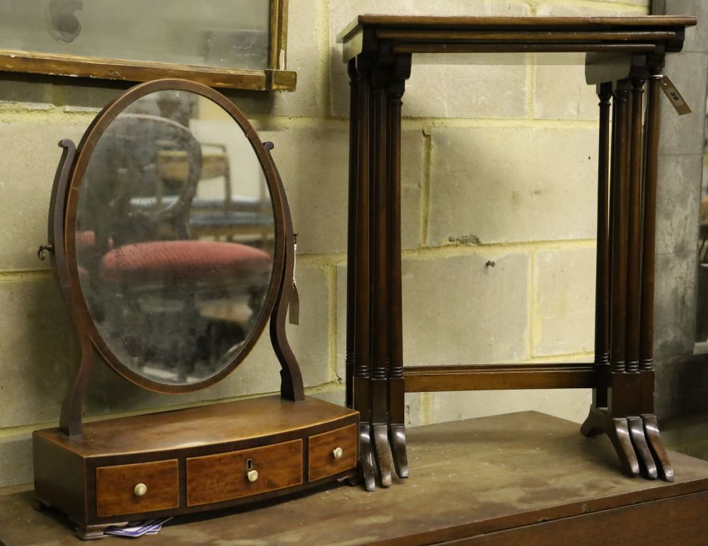 A nest of three mahogany tea tables, width 48cm depth 33cm height 67cm, and an oval swing frame toilet mirror with bow-fronted box base